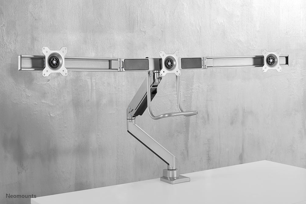 A Neomounts NM-D775DX3 ezüst egy gázrugós asztali tartó keresztléc és kar segítségével legfeljebb 27 hüvelykes (68,6 cm) lapos képernyőkhöz.