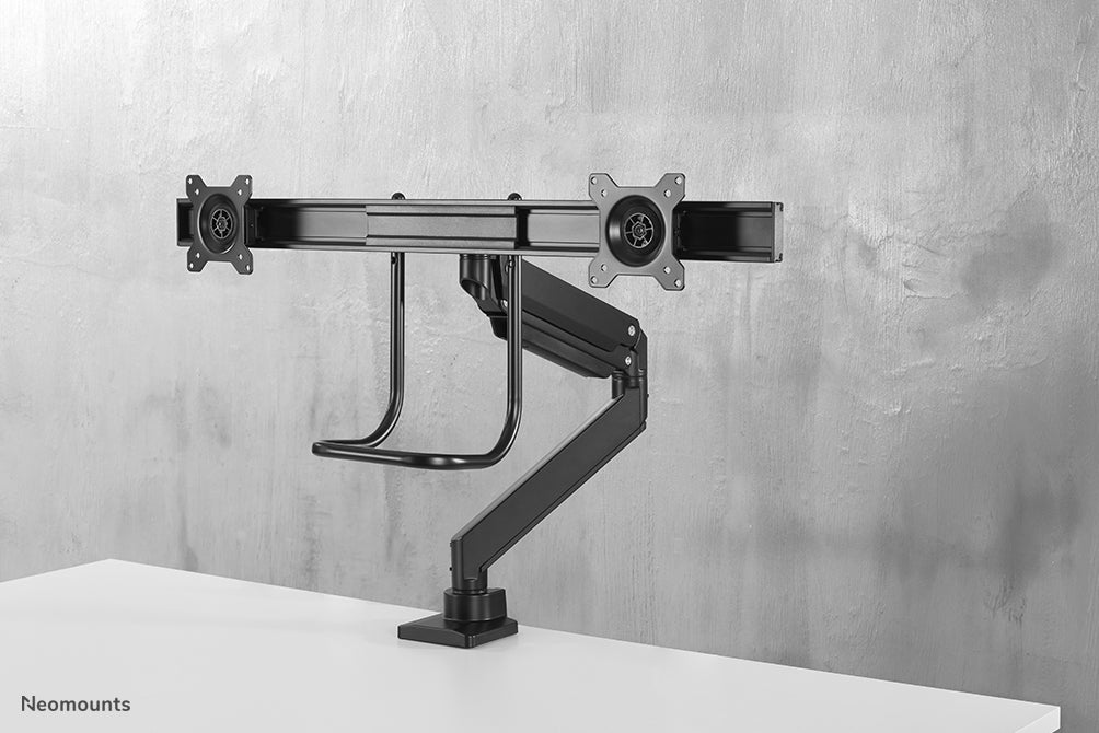 A Neomounts NM-D775DX fekete egy gázrugós asztali tartó keresztléc és kar segítségével legfeljebb 32 hüvelykes (81 cm) lapos képernyőkhöz.