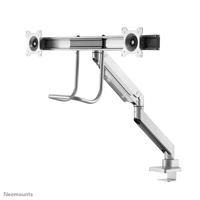 A Neomounts NM-D775DX ezüst egy gázrugós asztali tartó keresztléc és kar segítségével legfeljebb 32 hüvelykes (81 cm) lapos képernyőkhöz.