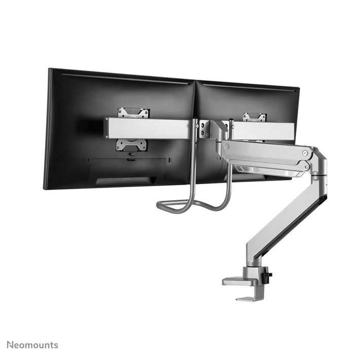 A Neomounts NM-D775DX ezüst egy gázrugós asztali tartó keresztléc és kar segítségével legfeljebb 32 hüvelykes (81 cm) lapos képernyőkhöz.
