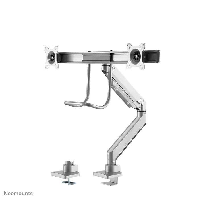 A Neomounts NM-D775DX ezüst egy gázrugós asztali tartó keresztléc és kar segítségével legfeljebb 32 hüvelykes (81 cm) lapos képernyőkhöz.